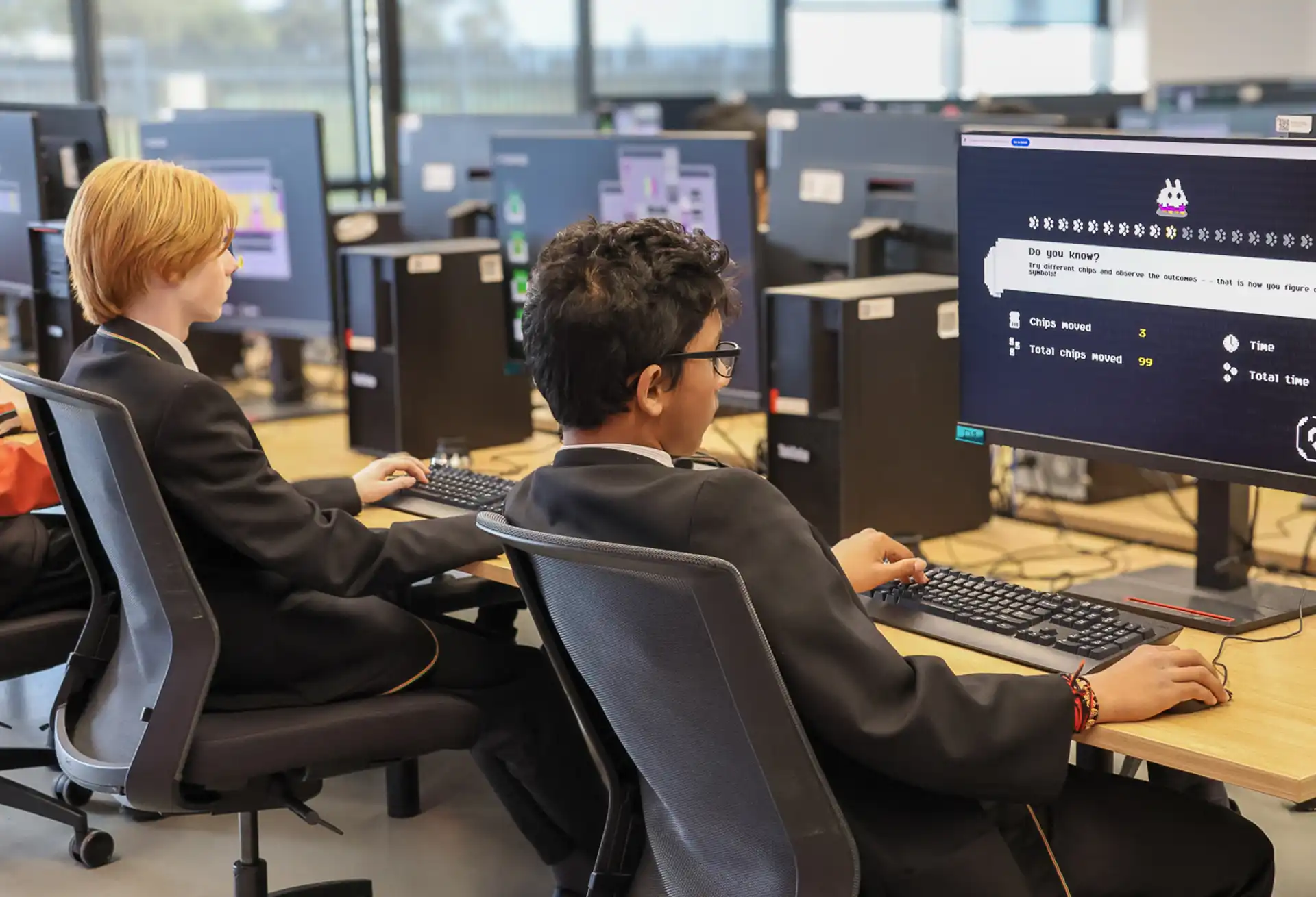 Two students sitting at computers.