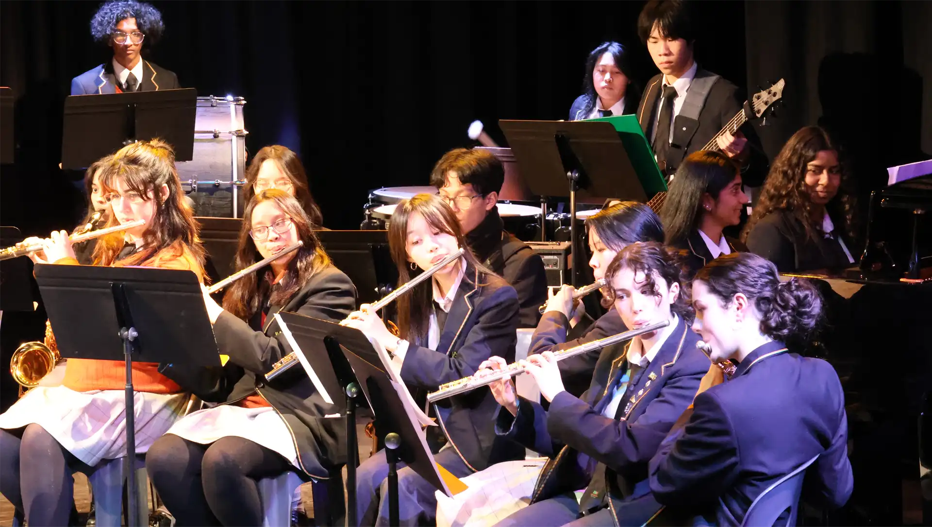 Instrumental music students playing instruments in a student orchestra