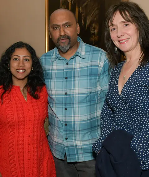 Three parents facing camera