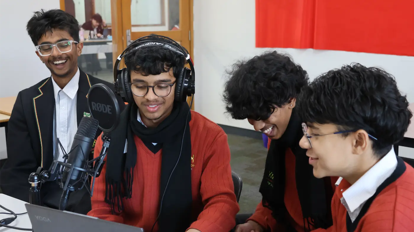 Four students recording a podcast