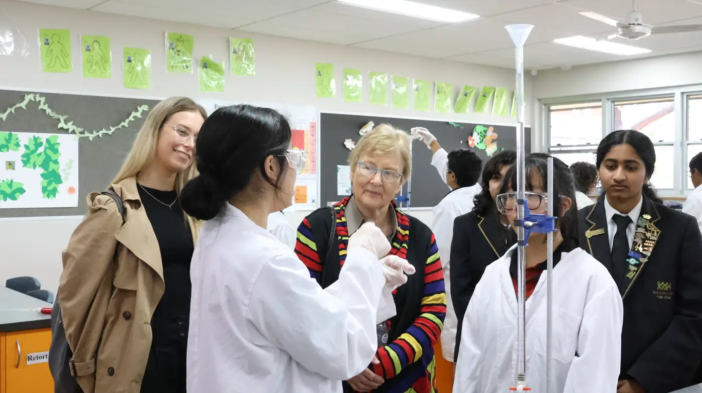 Professory Cory with 3 female students and an alumni student