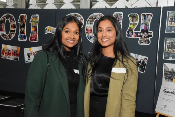 Two young woman posing for a picture