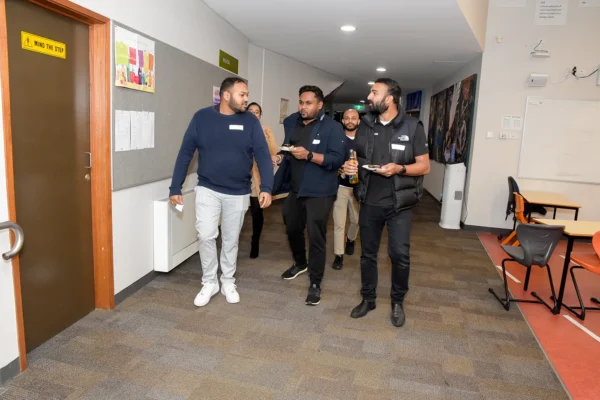 3 Alumni touring the school