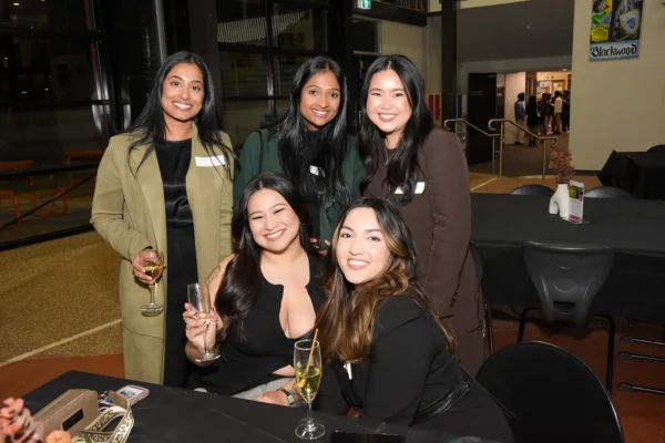 A group of alumni posing for a picture