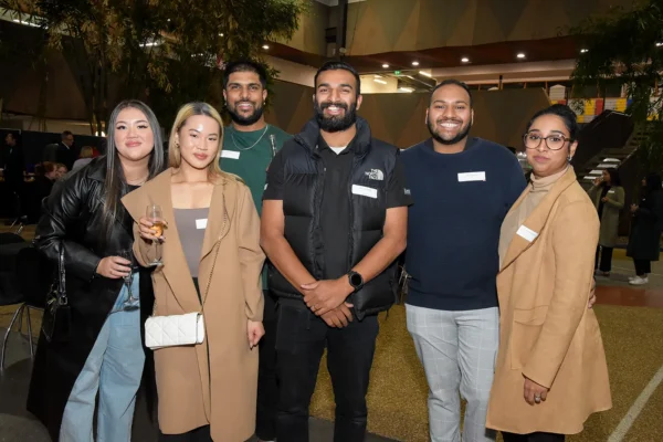 A group of alumni posing for a picture